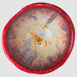 Discover the Kattu Coccinella Ceramic Bowl, featuring a red exterior with a burn effect, blue ripple inside, and a natural burning glaze. Australian-made ceramic bowl with a red exterior and burn effect, featuring a blue ripple design inside on a white background with a natural burning glaze.