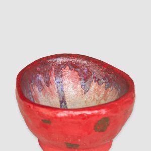 Discover the Kattu Coccinella Ceramic Bowl, featuring a red exterior with a burn effect, blue ripple inside, and a natural burning glaze. Australian-made ceramic bowl with a red exterior and burn effect, featuring a blue ripple design inside on a white background with a natural burning glaze.