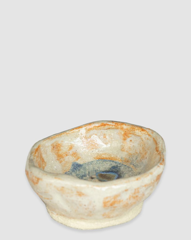 Handmade Australian ceramic bowl with an earthy neutral glaze and subtle blue accents, perfect for everyday use.
