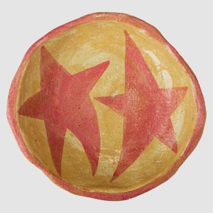 Australian-made ceramic bowl with a natural burnt glaze background and hand-painted pink stars connected in an artistic design.