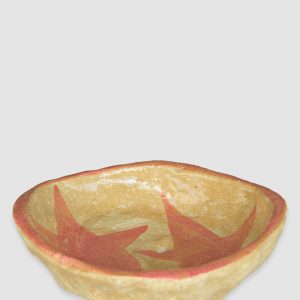 Australian-made ceramic bowl with a natural burnt glaze background and hand-painted pink stars connected in an artistic design.