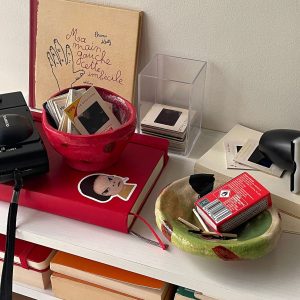 Discover the Kattu Coccinella Ceramic Bowl, featuring a red exterior with a burn effect, blue ripple inside, and a natural burning glaze. Australian-made ceramic bowl with a red exterior and burn effect, featuring a blue ripple design inside on a white background with a natural burning glaze.