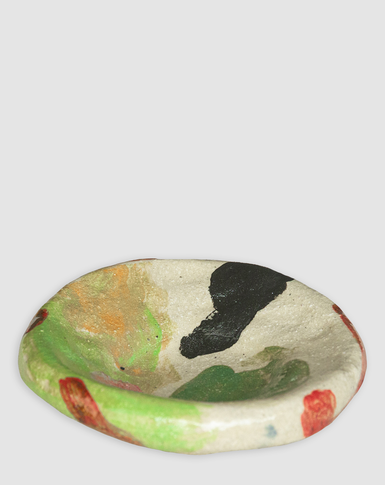 Discover the Kattu Frog Ceramic Dish, featuring a soft cream base scattered with vibrant green playful colour blobs, and a natural burning glaze. Handcrafted in Australia, perfect for trinkets, jewellery, or as a decorative accent.