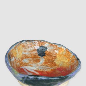 Discover the Kattu Daub Ceramic Bowl, featuring a blue exterior with colour splatters, red painted interior, and a natural burning glaze. Handcrafted in Australia, perfect for trinkets, jewellery, or as a decorative accent.