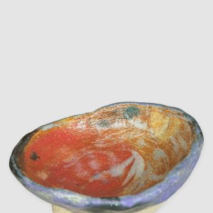 Discover the Kattu Daub Ceramic Bowl, featuring a blue exterior with colour splatters, red painted interior, and a natural burning glaze. Handcrafted in Australia, perfect for trinkets, jewellery, or as a decorative accent.