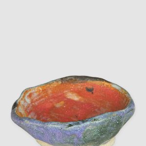 Discover the Kattu Daub Ceramic Bowl, featuring a blue exterior with colour splatters, red painted interior, and a natural burning glaze. Handcrafted in Australia, perfect for trinkets, jewellery, or as a decorative accent.